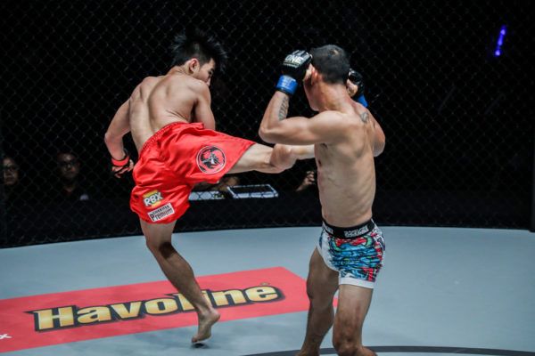 Philippine mixed martial artist Joshua Pacio throws a spinning back kick at Roy Doliguez