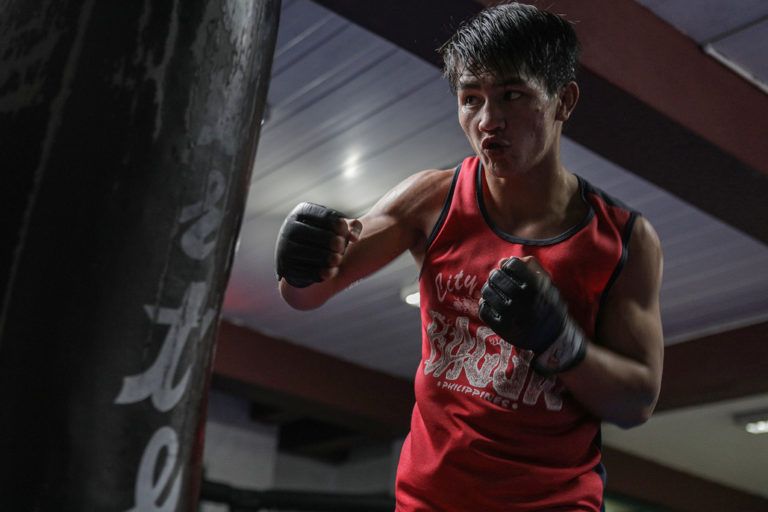 Flyweight mixed martial artist Danny Kingad punches a heavy bag