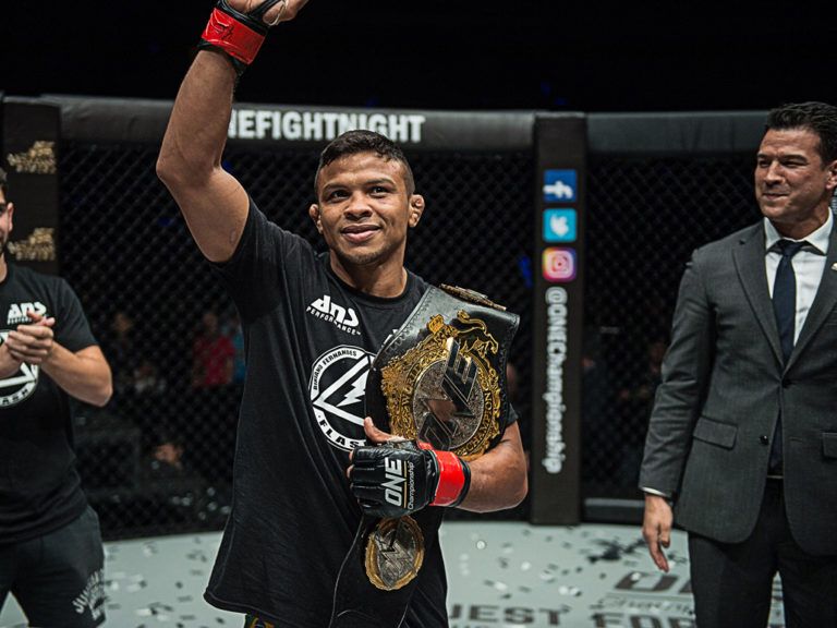 Bibiano Fernandes celebrates with the ONE Bantamweight World Title belt
