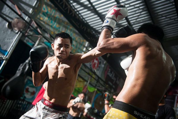 ONE Championship strawweight contender Stefer Rahardian punches with his pad holder