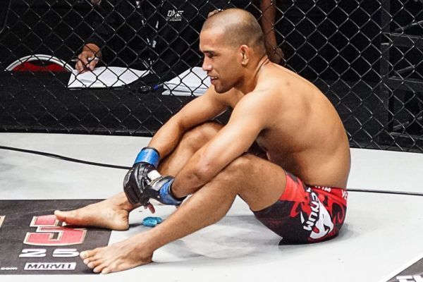 Philippine mixed martial artist Rene Catalan sitting down in the cage