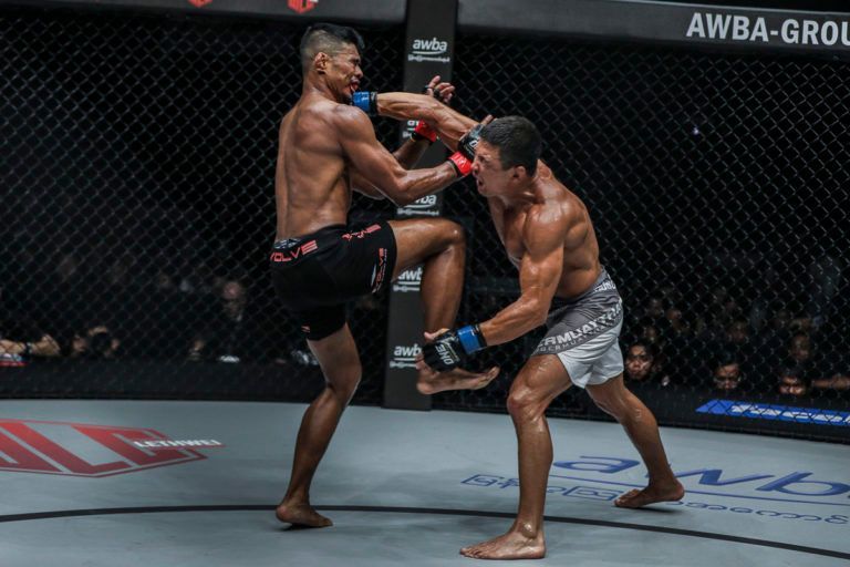 Russian MMA fighter Timofey Nastyukhin catches a kick and throws a punch