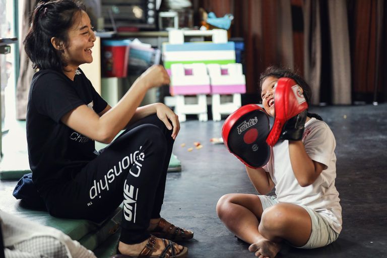 Rika Ishige and a child holds focus mitts