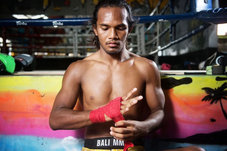 Malaysian martial artist Muhammad Aiman wraps his hands in red