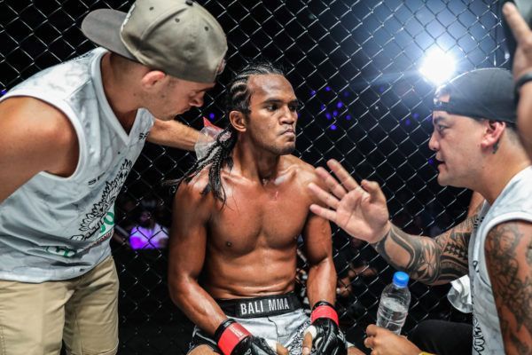 Muhammad Aiman sits in the corner