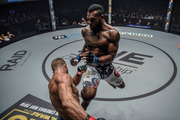 Brazilian MMA fighter Leandro Ataides leaps with a flying knee