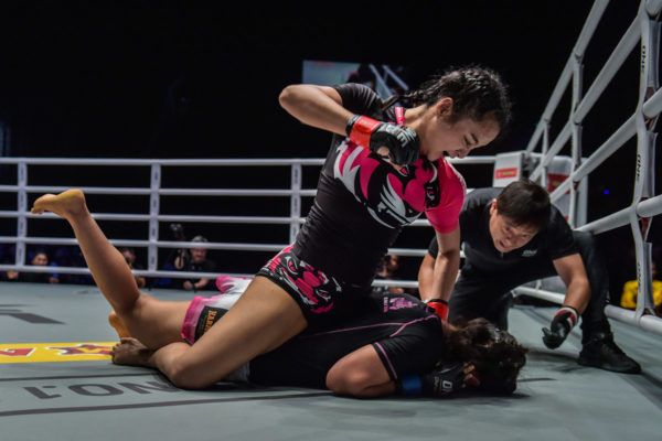 Thai mixed martial atist Rika Ishige punches her opponent with ground and pound