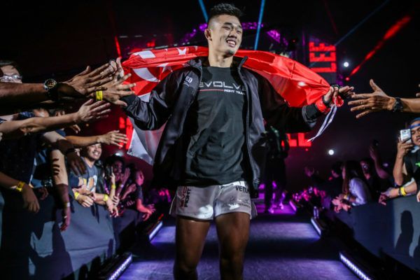 ONE Lightweight World Champion Christian Lee walks with Singapore flag