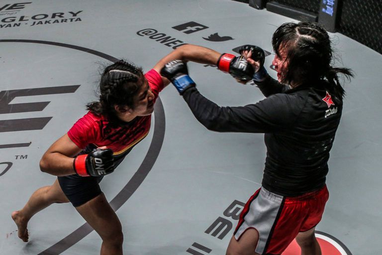 Malaysian mixed martial artist Jihin Radzuan smashes Jenny Huang with a punch