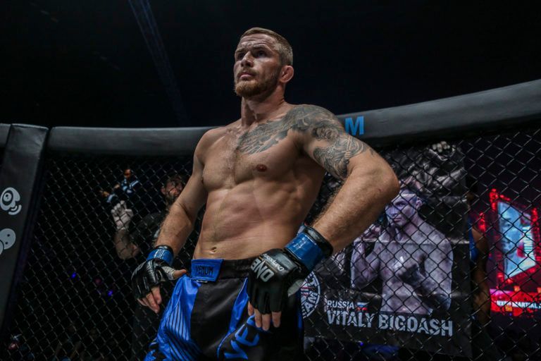 Russian MMA fighter Vitaly Bigdash stands ready before battle.