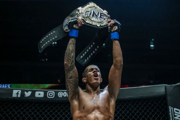 ONE Flyweight World Champion Adriano Moraes raises his belt