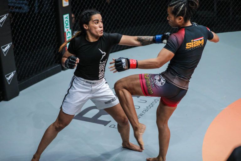 Indian mixed martial artist Puja Tomar unloads a straght left o Priscilla Hertati Lumban Gaol
