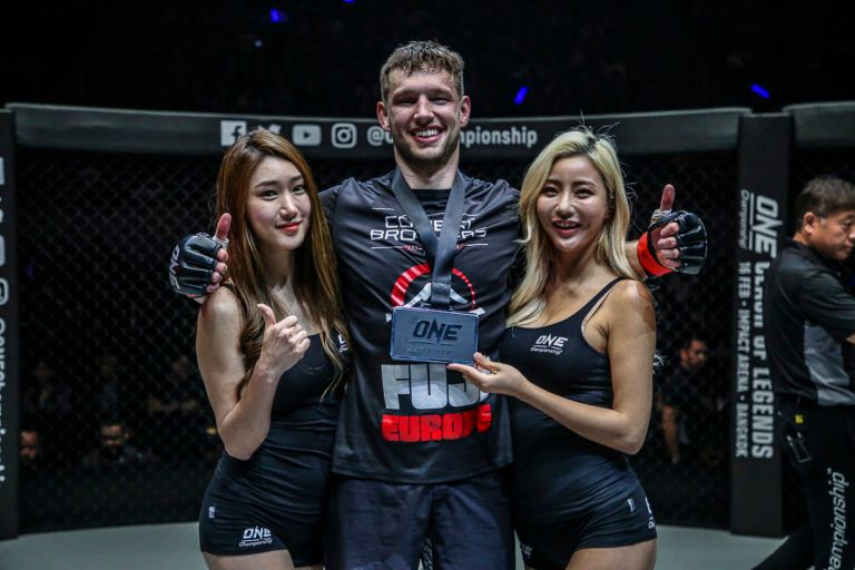 Renier De Ridder celebrates his debut win with the ring girls