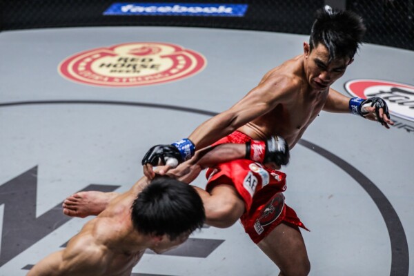 Team Lakay's Joshua Pacio throws a heavy kick at Yosuke Saruta at ONE: ROOTS OF HONOR in their ONE Strawweight World Title tilt.