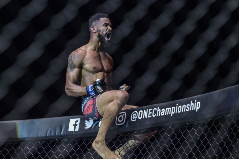 Dutch MMA Fighter Pieter Buist sits on top of the cage