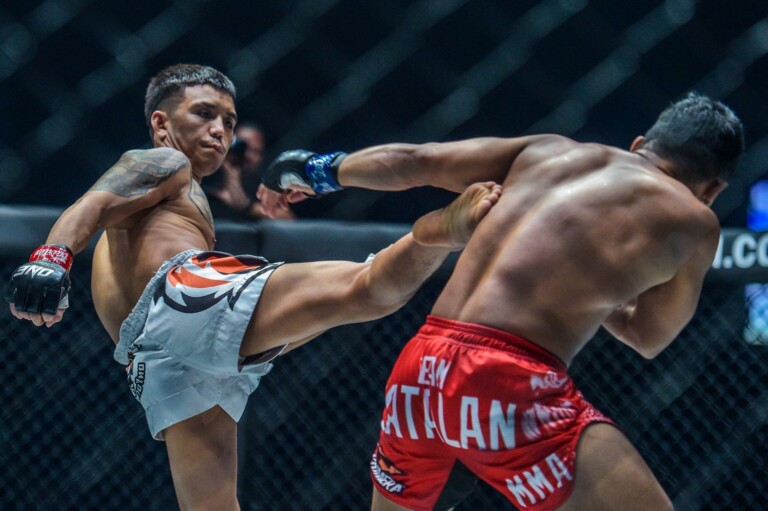 Thailand's Pongsiri Mitsatit throws a roundhouse kick at Robin Catalan