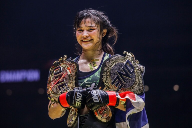 Stamp Fairtex with her ONE Atomweight Muay Thai and Kickboxing World Title belts