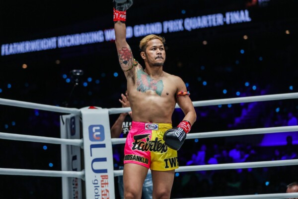Muay Thai legend Yodsanklai IWE Fairtex raises his arm before battle