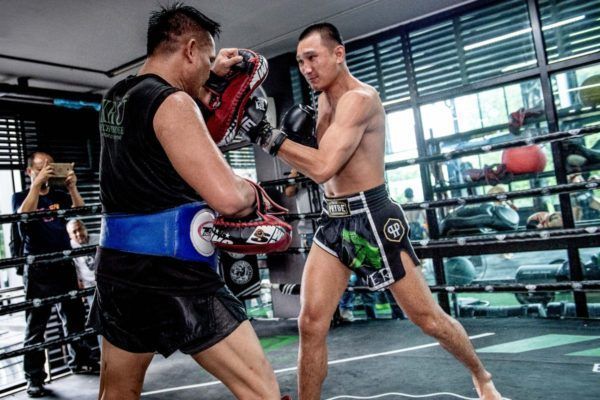 ONE Featherweight Muay Thai World Champion Petchmorakot Petchyindee Academy punches the pad in his Muay Thai shorts