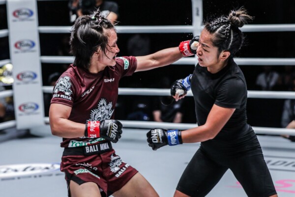 Myanmar national boxing champion Bozhena Antoniyar hits a jab on Bi Nguyen