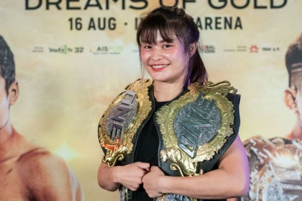 Stamp Fairtex poses with the ONE Atomweight Kickboxing and Muay Thai World Titles