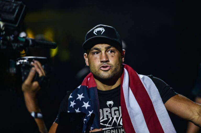 Eddie Alvarez enters the Mall Of Asia Arena with the American flag draped around him