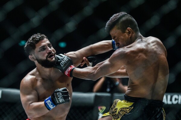 Cuban grappler Gustavo Balart punches Cambodian martial arts star Chan Rothana