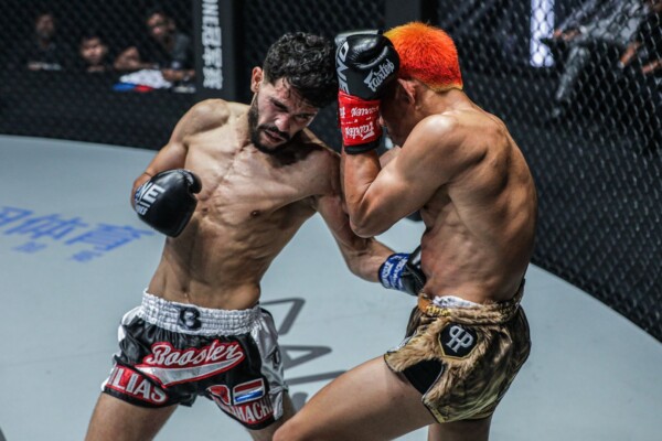 Ilias Ennahachi lands a body shot on Petchdam
