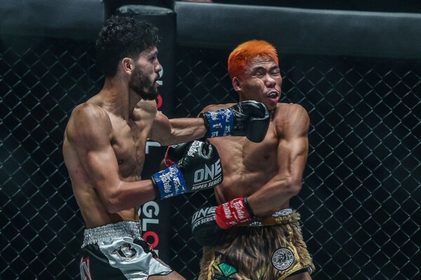 The Netherlands' Ilias Ennahachi cracks Thai hero Petchdam with a left