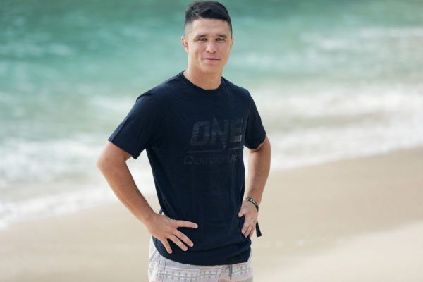 Reece McLaren stands on the beach
