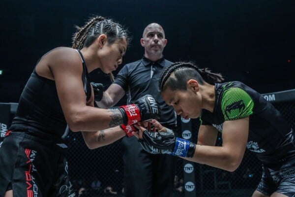 Angela Lee and Xiong Jing Nan touch gloves before their rematch