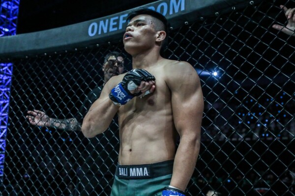 Indonesian MMA fighter Elipitua Siregar stands inside the cage, ready for battle