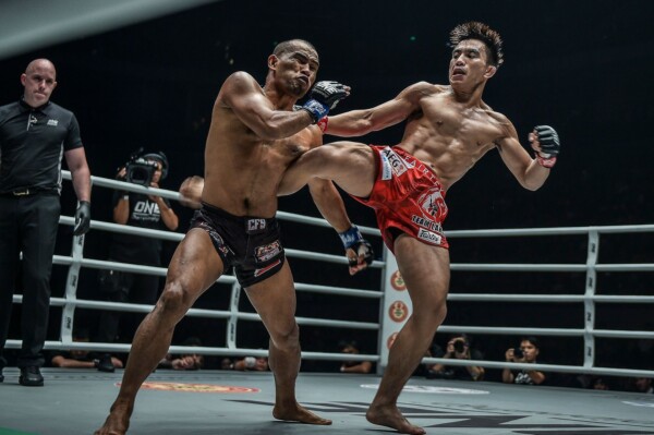 ONE Strawweight World Champion Joshua Pacio connects with a body kick on Rene Catalan