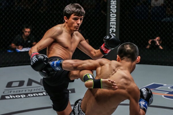 Russian striking ace Alaverdi Ramazanov exchanges shots with Chinese athlete Zhang Chenglong