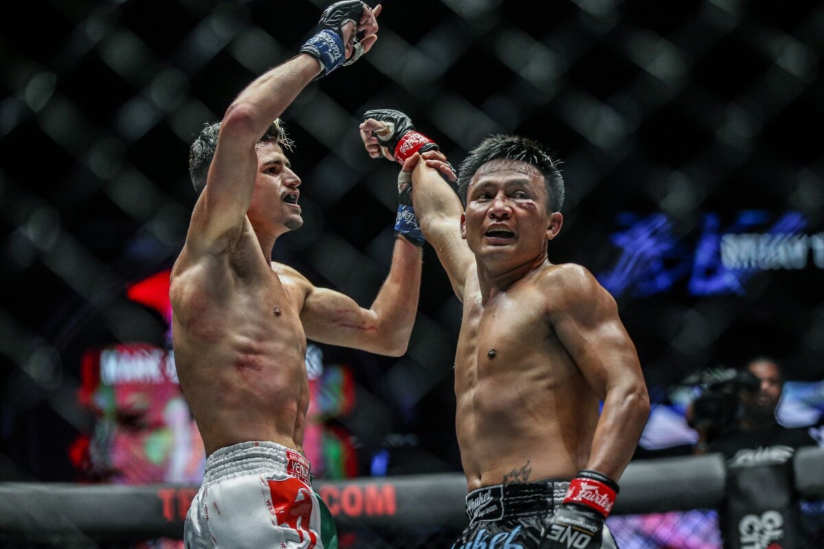 The living Muay Thai Legend Lerdsila raises his victor's hand, Elias Mahmoudi
