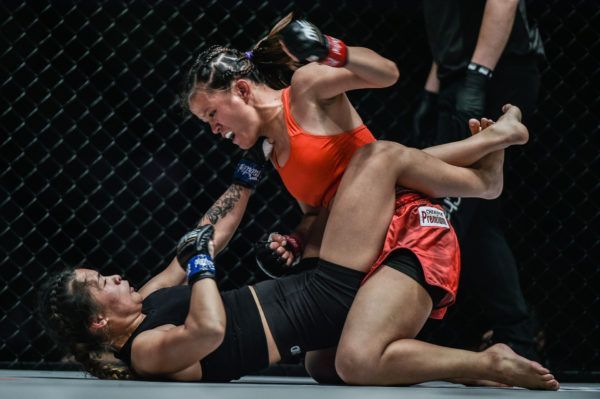 The Philippines' Gina Iniong punches Asha Roka on the ground