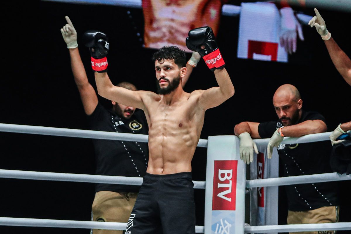 Ilias Ennahachi raises his arms, ready for battle
