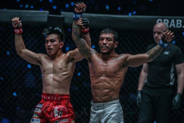Joshua Pacio and Alex Silva raise each other's arms