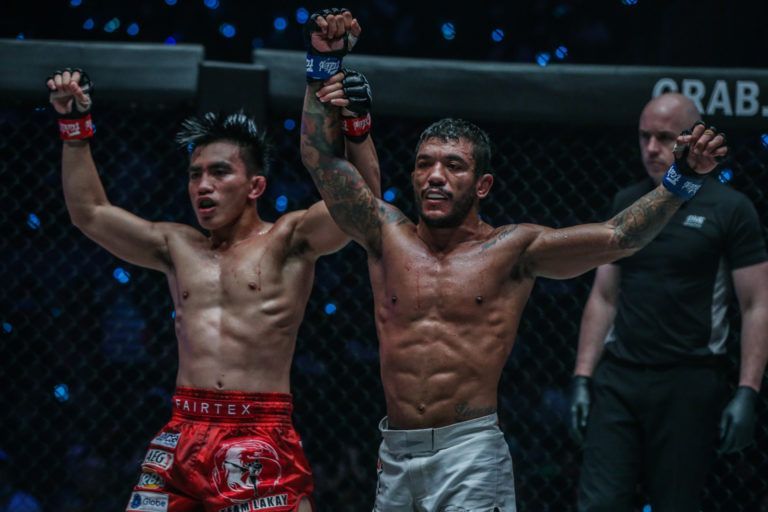 Joshua Pacio and Alex Silva raise each other's arms