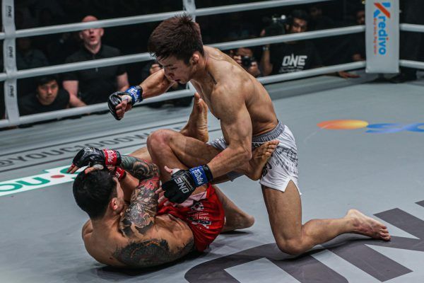 Japanese featherweight Koyomi Matsushima punches South Korea's Kim Jae Woong