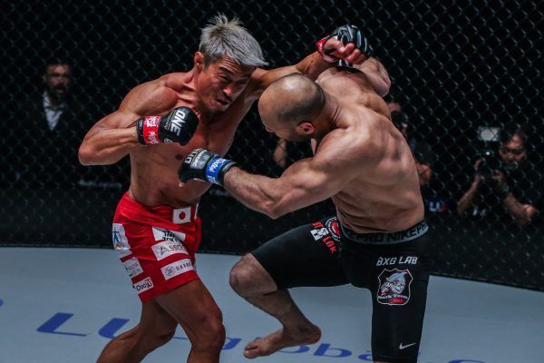 Japanese-South Korean legend Yoshihiro Akiyama cracks Sherif Mohamed with a cross