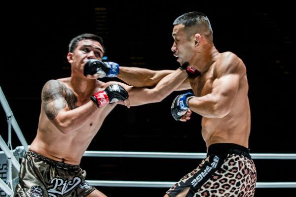 Japanese fighter Akihiro Fujisawa punches Pongsiri Mitsatit