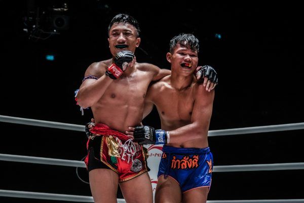 Muay Thai fighters Mongkolpetch Petchyindee Academy and Sok Thy embrace after their three-round war at ONE: NO SURRENDER III