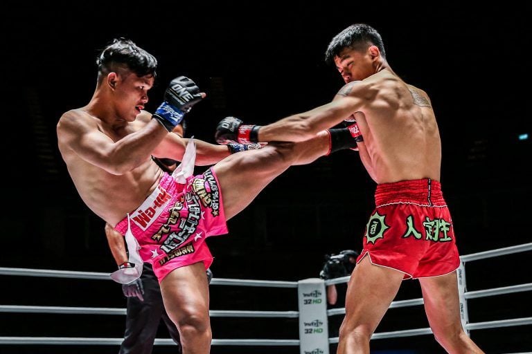 Cambodia's Sok Thy throws a kick at Huang Ding