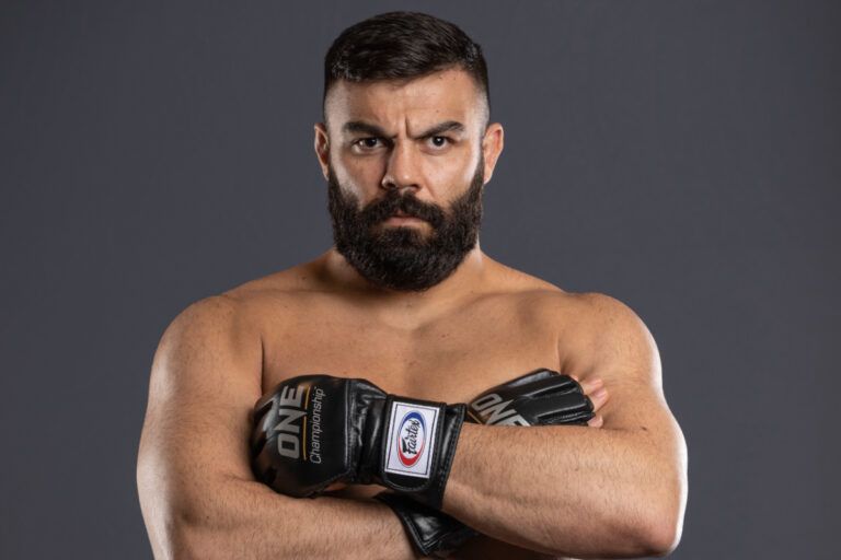 Iranian MMA fighter Amir Aliakbari crosses his arms