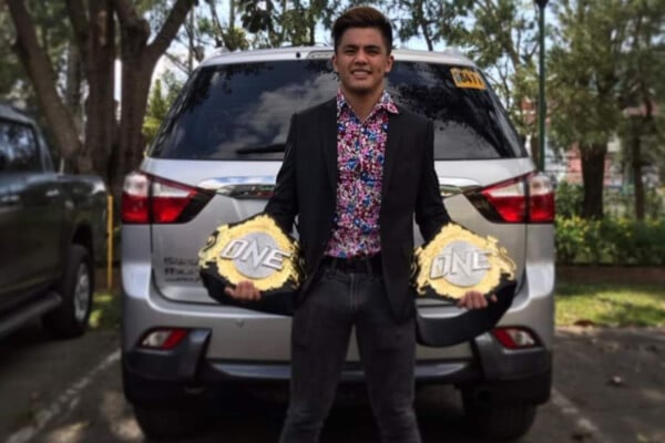 Jhanlo Sangiao poses with ONE Championship belts