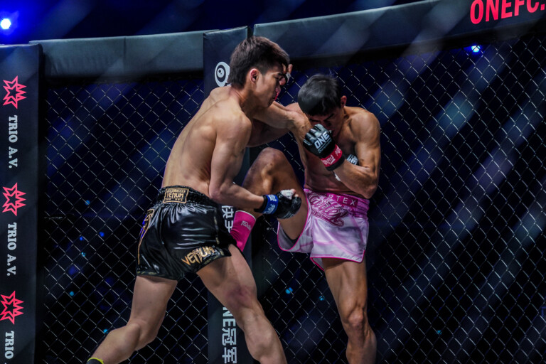 Tawanchai pressures Saemapetch against the Circle Wall at ONE: HEAVY HITTERS.