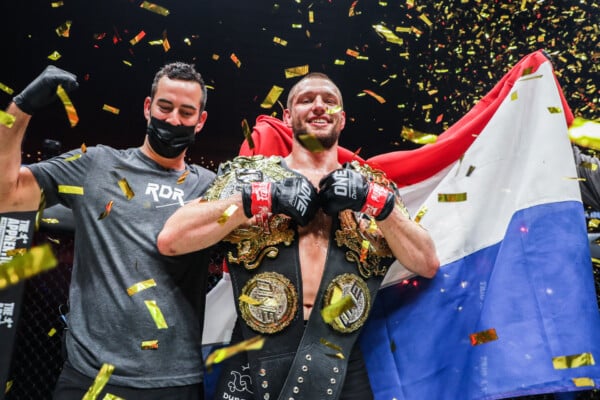 Reinier De Ridder celebrates with the ONE Middleweight and Light Heavyweight World Championship belts after his fight at ONE: FULL CIRCLE