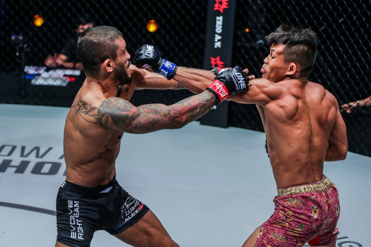 Alex Silva and Adrian Mattheis trade punches during their strawweight MMA fight at ONE: LIGHTS OUT