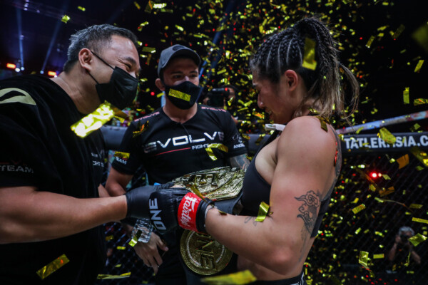 Angela Lee celebrates her successful defense of the ONE Atomweight World Championship with her husband Bruno Pucci and her father Ken Lee